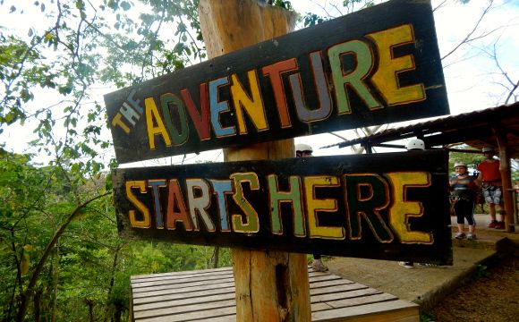 The sign at the beginning of the canopy / zipline course. But it could just as well refer to your arrival in the Caribbean where a plethora of adventure awaits you!